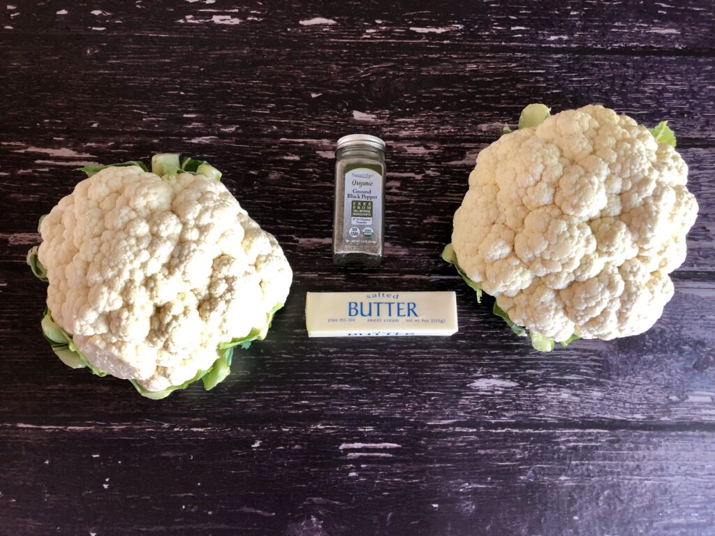 2 heads of cauliflower, a stick of butter, and jar of black pepper