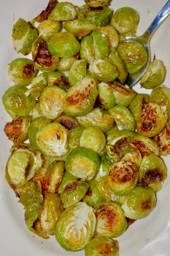 Bowl full of browned, halved, roasted Brussels Sprouts