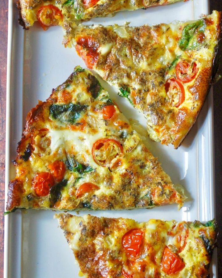 Four slices of frittata on a white rectangle plate