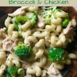 brown bowl filled with cheesy spiral pasta with broccoli and chicken