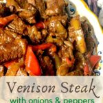 Decorative dish filled with venison steak, onions & peppers