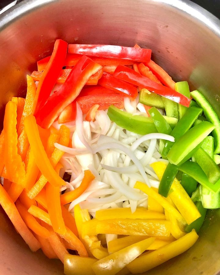 Sliced rainbow peppers and onion in the Instant Pot