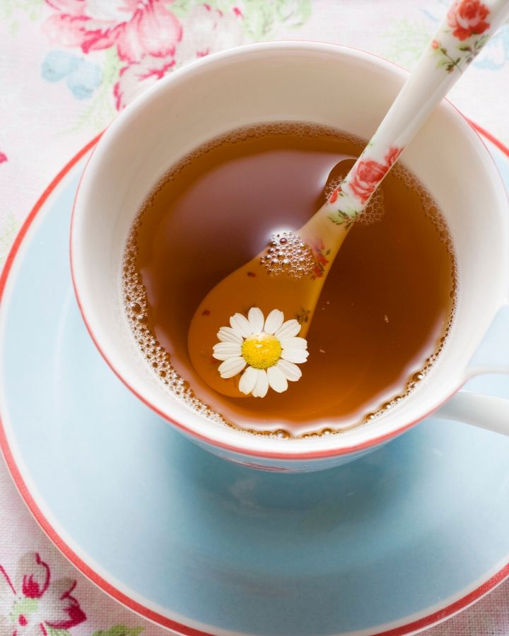 light blue and pink tea cup with fancy spoon filled with tea