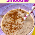 Smoothie in glass garnished with cinnamon with polka dot straw