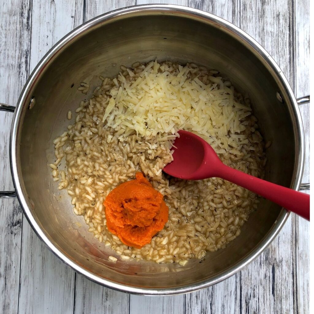 stirring parmesan cheese and pumpkin into rice