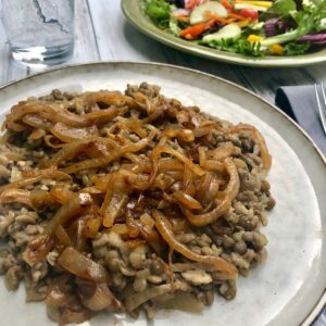 plate of mujadara topped with caramelized onions