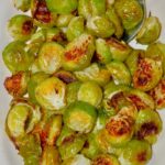 oven roasted Brussels Sprouts in dish with spoon