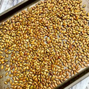 a baking sheet full of roasted, spiced pepitas