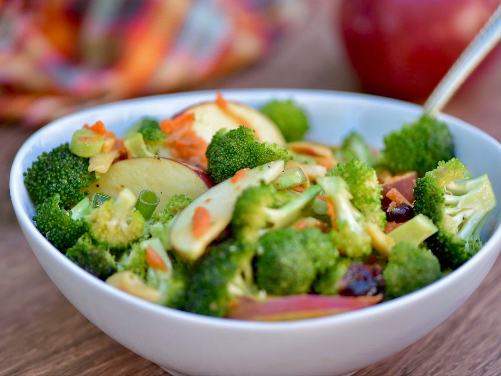 Broccoli Crunch Salad with Apples and Almonds in a white bowl

