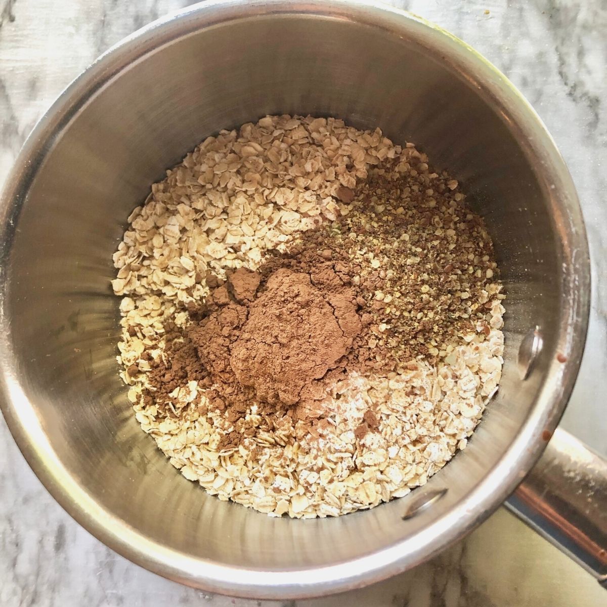 oats, flax/hemp seed, and cocoa powder in a sauce pan