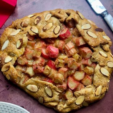 a rhubarb filled galette with a browned crust and slivered almonds