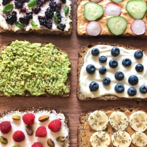 six slices of toast with various healthy toppings.