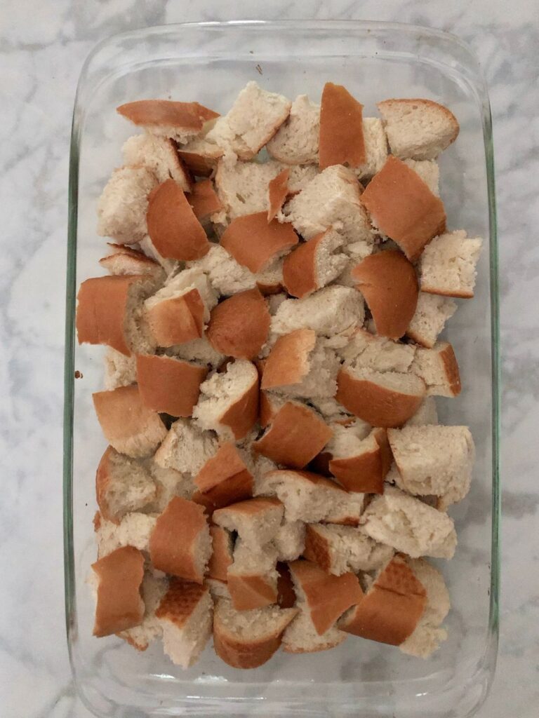 Bread pieces in a 9x13 baking pan.