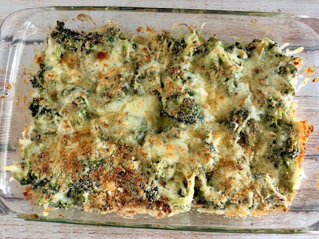 a 9x13 clear casserole dish filled with broccoli cheese casserole.