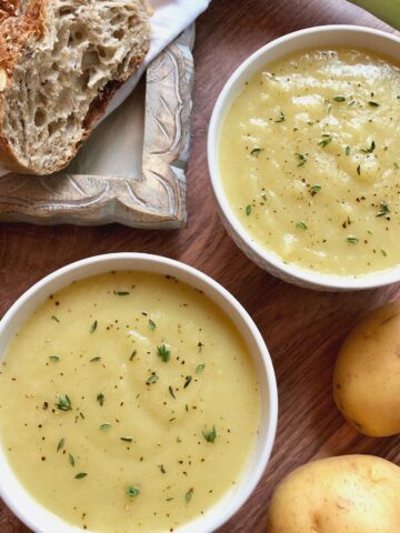 2 bowls of potato soup with crusty bread.