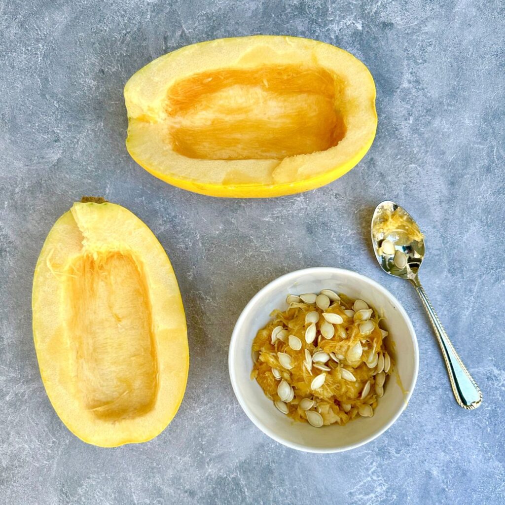 a halved spaghetti squash with seeds scooped out.