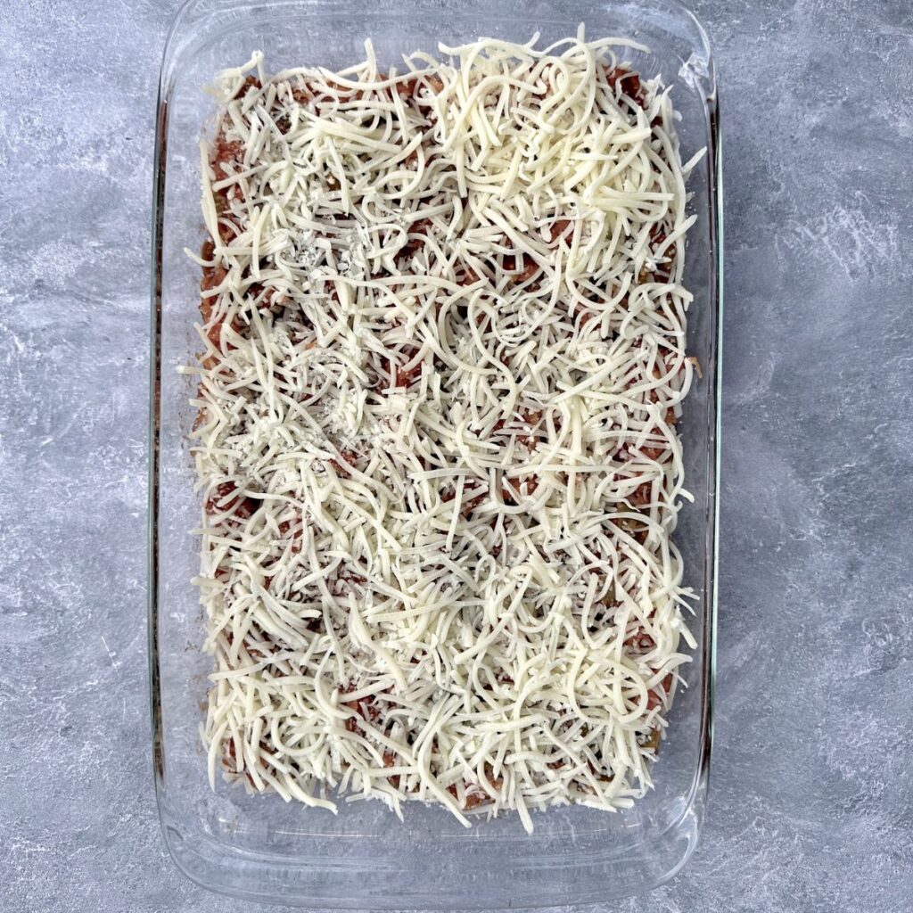 Mozzarella cheese sprinkled on top of a 9x13 casserole.