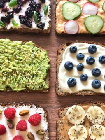 six slices of whole grain toast with various fruit, veggie, nuts, seed toppings.
