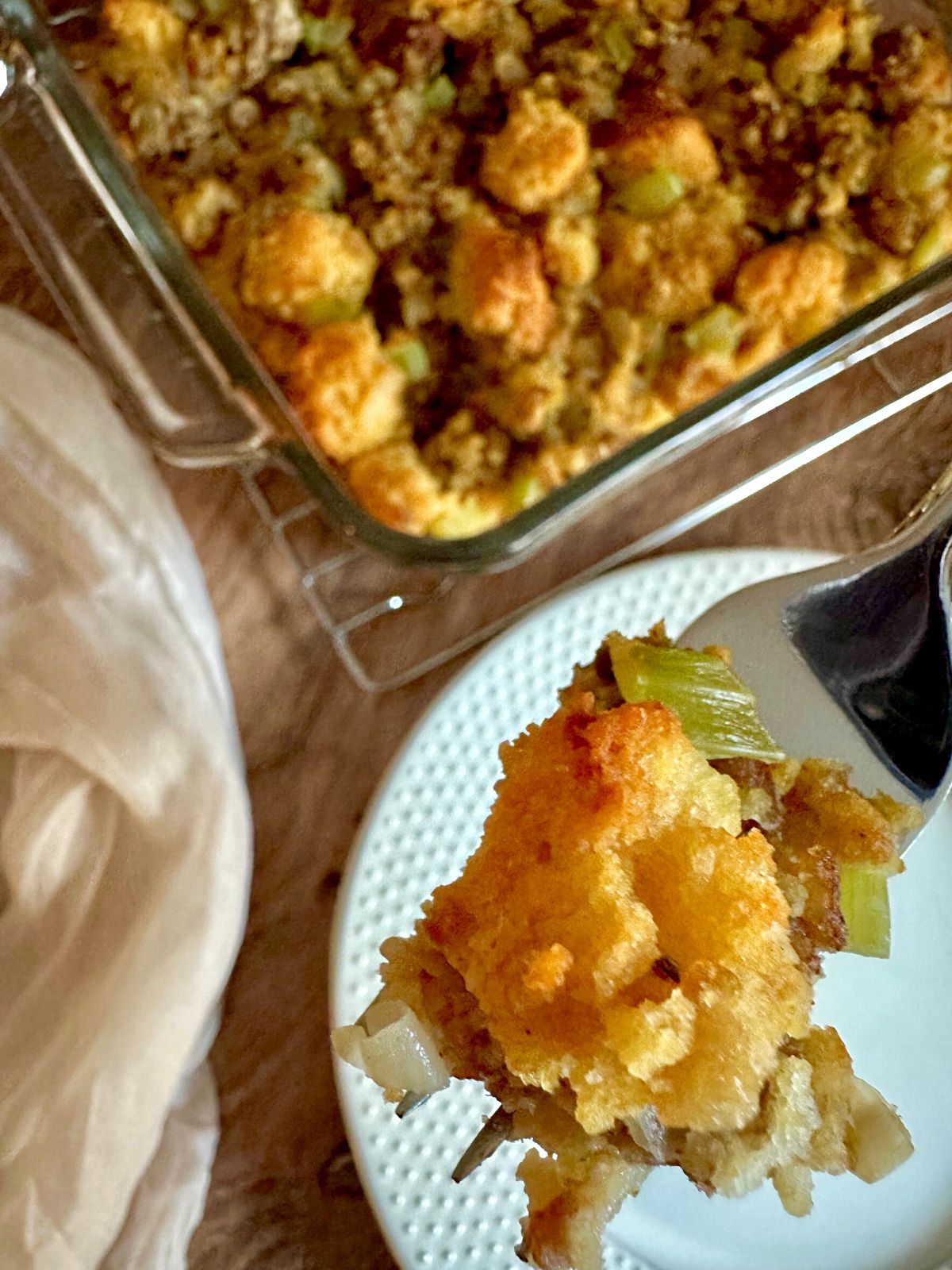 a close-up bite of cornbread stuffing on a fork.