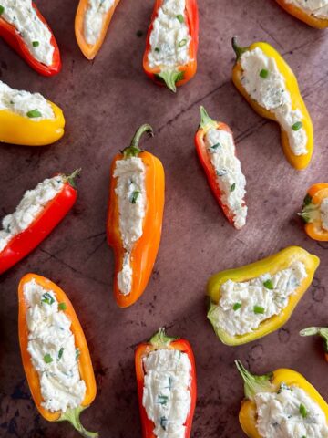 red, orange, and yellow mini peppers stuffed with cream cheese