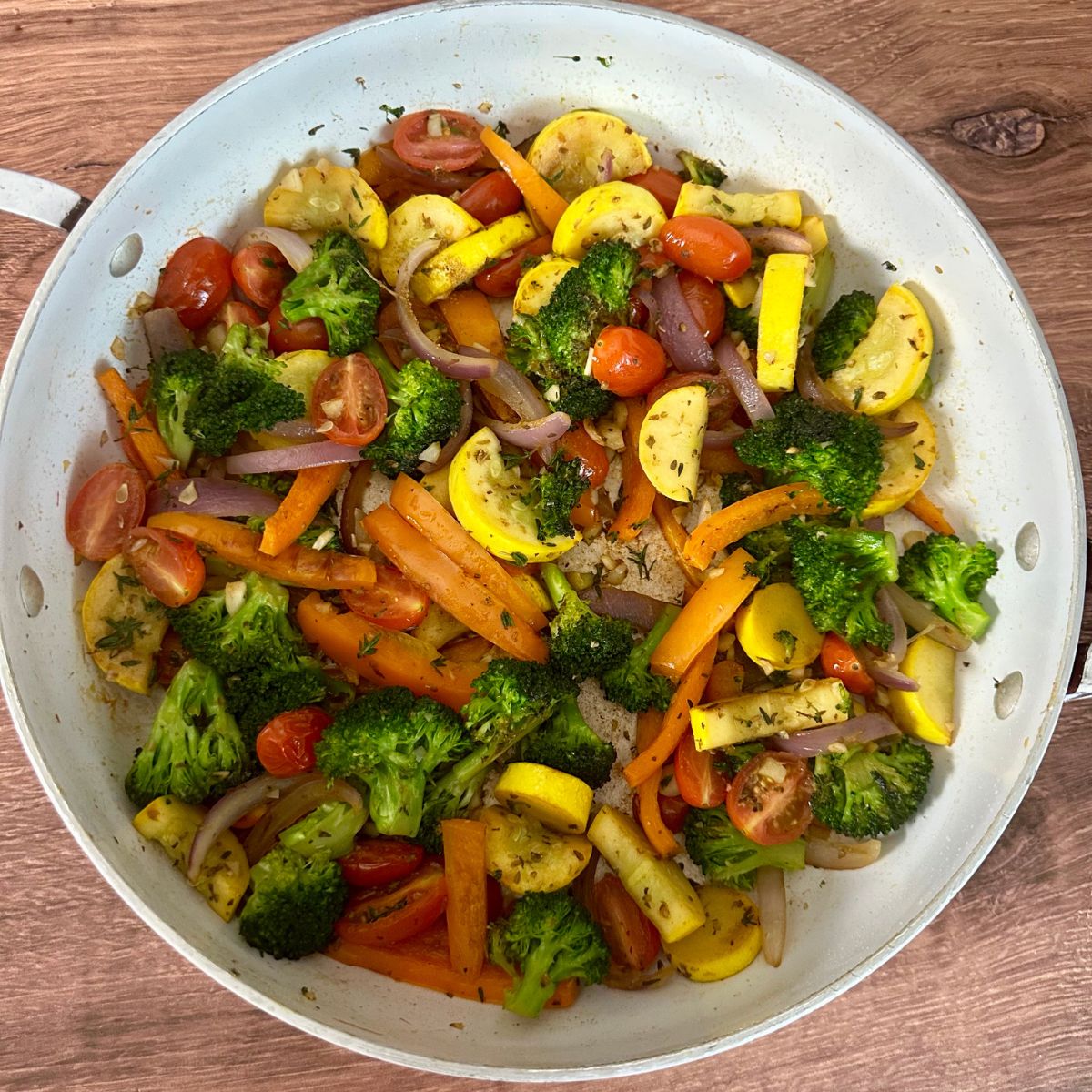 sauteed broccoli, yellow squash, orange bell pepper, red onion, grape tomatoes and spices in a large skillet.