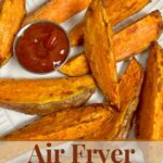 sweet potato wedges on a white place with small cup of ketchup.