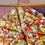 A round pizza topped with tomato, artichokes, orange pepper, red onion, and cheese.