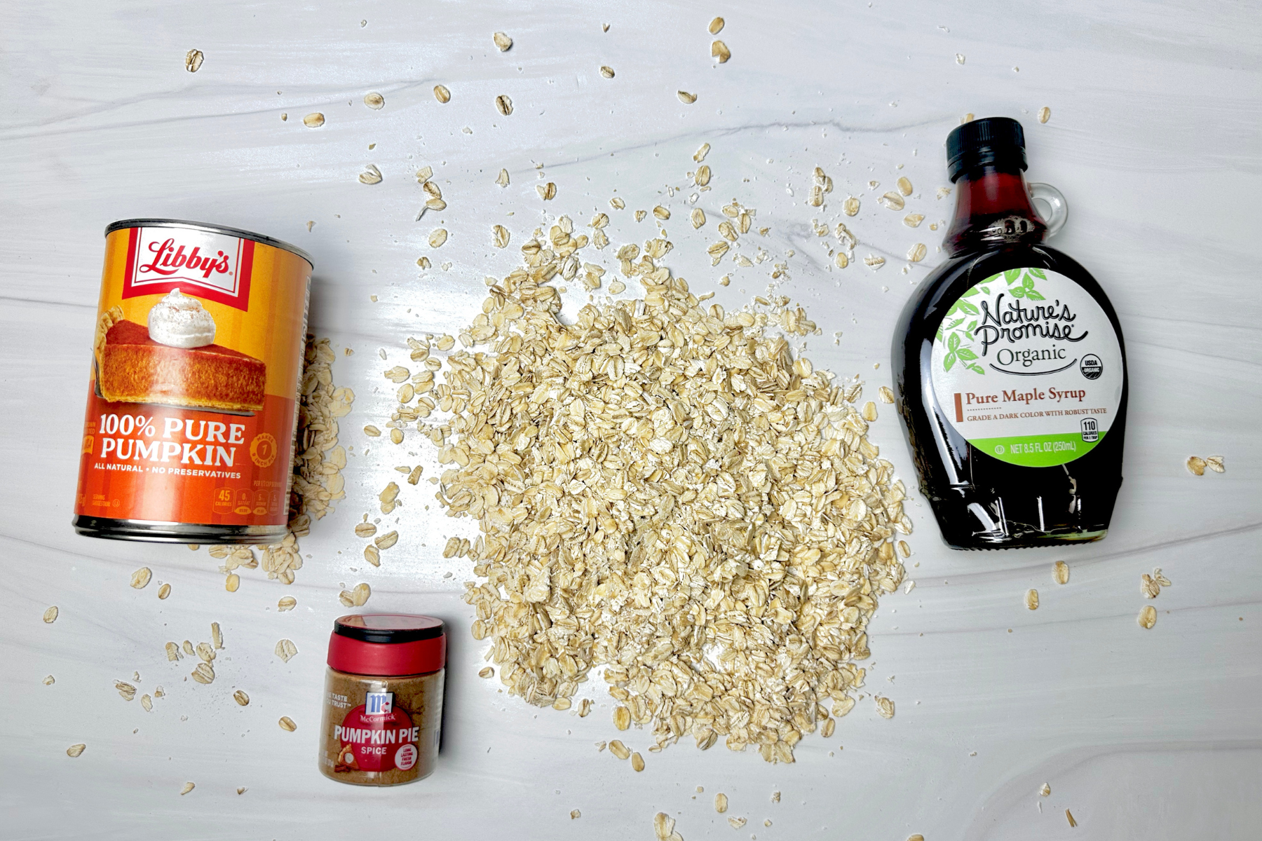 a can of libby pumpkin, small container of McCormick PUmpkin pie spice, rolled oats, and Nature's Promise 100% pure maple syrup